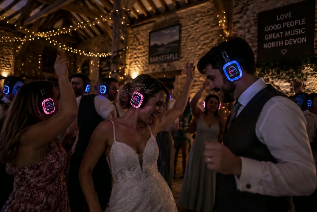 Wedding guests dancing in No Noise silent disco headphones inside a North Devon barn near Barnstaple
